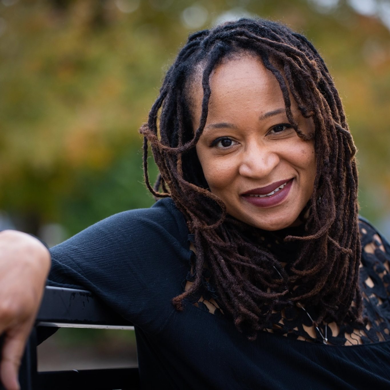 Pic of writer Jacinda Townsend sitting casually on a bench.